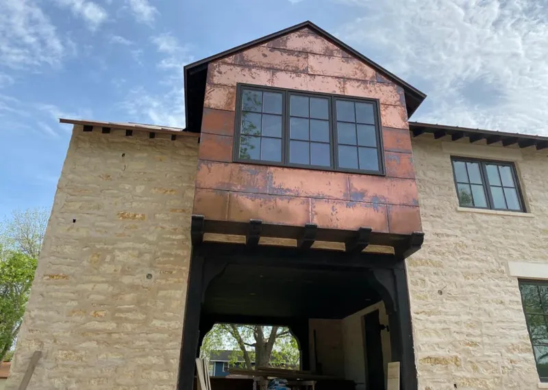 Copper metal panel facade on a stone building for Skylight Installation in Asheville