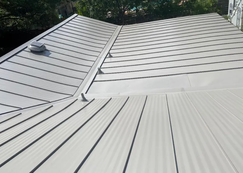 Solar attic fan installed on a metal roof for Roof Ventilation in Asheville